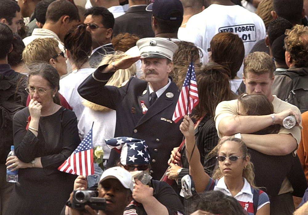 Award of Excellence, Photographer of the Year - Amy Sancetta / Associated PressMourners of victims of the attack on the World Trade Center reflect, salute, and comfort each other as they listen to the playing of taps during ground zero ceremonies marking the one year anniversary of the attack in New York on Sept. 11, 2002.  