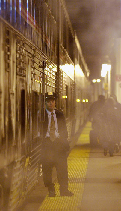 Award of Excellence, Photographer of the Year - Amy Sancetta / Associated PressSuffering from a budget shortage, AMTRAK last year considered cutting it's cross country train routes.  I rode the California Zephyr from Chicago to San Francisco to try to show what a loss that would be. Conductor Mike Tuck waits amid the mist for the last passengers to board the California Zephyr at Union Station in Chicago on April 22, 2002.  The Zephyr begins its 2438 miles journey west to Emoryville, Ca., from Chicago.