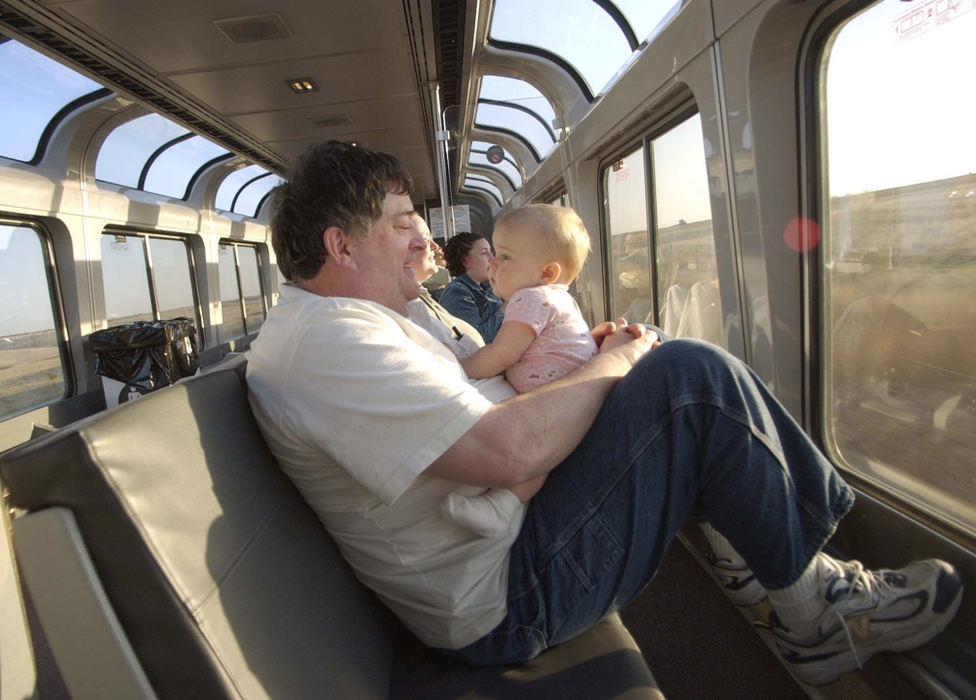 Award of Excellence, Photographer of the Year - Amy Sancetta / Associated PressEnjoying the view from the sightseer lounge car, John Weimers plays with his granddaughter Raven Elizabeth Stoneking  as the Zephyr approaches McCook, Neb. on April 24, 2002.  Weimers and his family were traveling from Knoxville, Ill. to Provo, Utah for his daughter's wedding.  