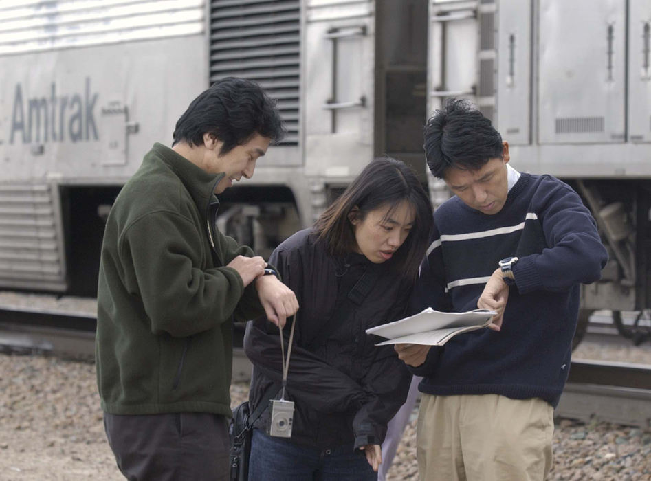 Award of Excellence, Photographer of the Year - Amy Sancetta / Associated PressFrom left, Kenji Nakamura of New York, and married couple Mitsuyo and Toshihiko Fujita, of Washington, D.C., check their route guide and the time on April 26, 2002 as the California Zephyr makes a stop in Winnemucca, Nevada.   The Fujita's were traveling all around the country by rail before their 9-month visas ran out and they had to return to Japan.  