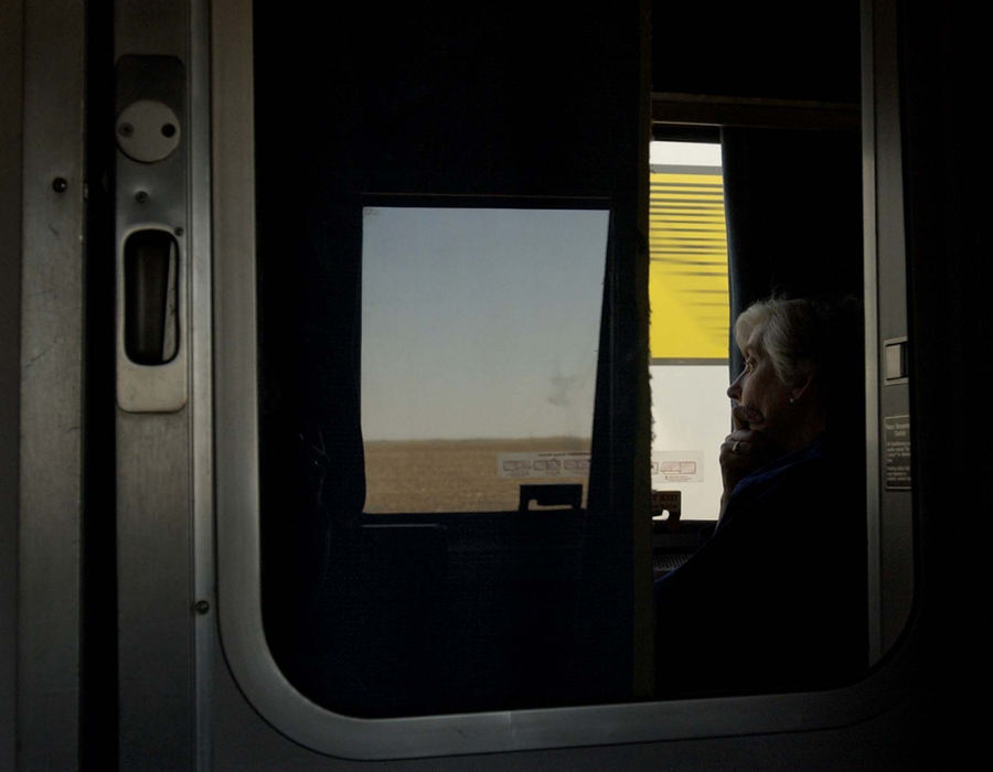 Award of Excellence, Photographer of the Year - Amy Sancetta / Associated PressFrom inside her sleeper car, Sylvia Lawrie of Wayne, Pa. looks out at the fields and a passing freight train near Culbertson, Neb. on April 24, 2002.  Culbertson and her husband took a train from Paoli, Pa. to Chicago before catching the Zephyr for their trip to San Francisco to attend their nephew's wedding. 