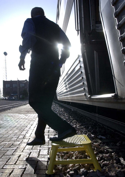 Award of Excellence, Photographer of the Year - Amy Sancetta / Associated PressSleeper car attendant Julius Hawkins hops off the train for a short stop in McCook, Neb. on April 24, 2002. 