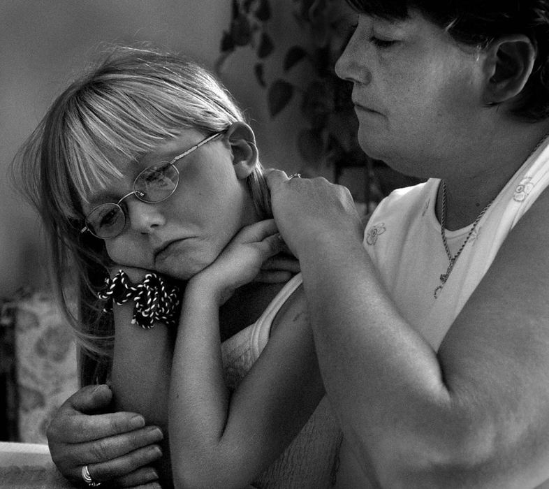 Award of Excellence, Photographer of the Year - Michael E. Keating / Cincinnati Enquirer Charlene Sizemore (right) comforts her granddaughter Cheynne Murphy, 6,vas they talk about Cheyenne's mother Stephanie Brewer, who along with her husband Gary Brewer, were killed in an auto accident. The Brewers, newlyweds, left behind five children between them. 