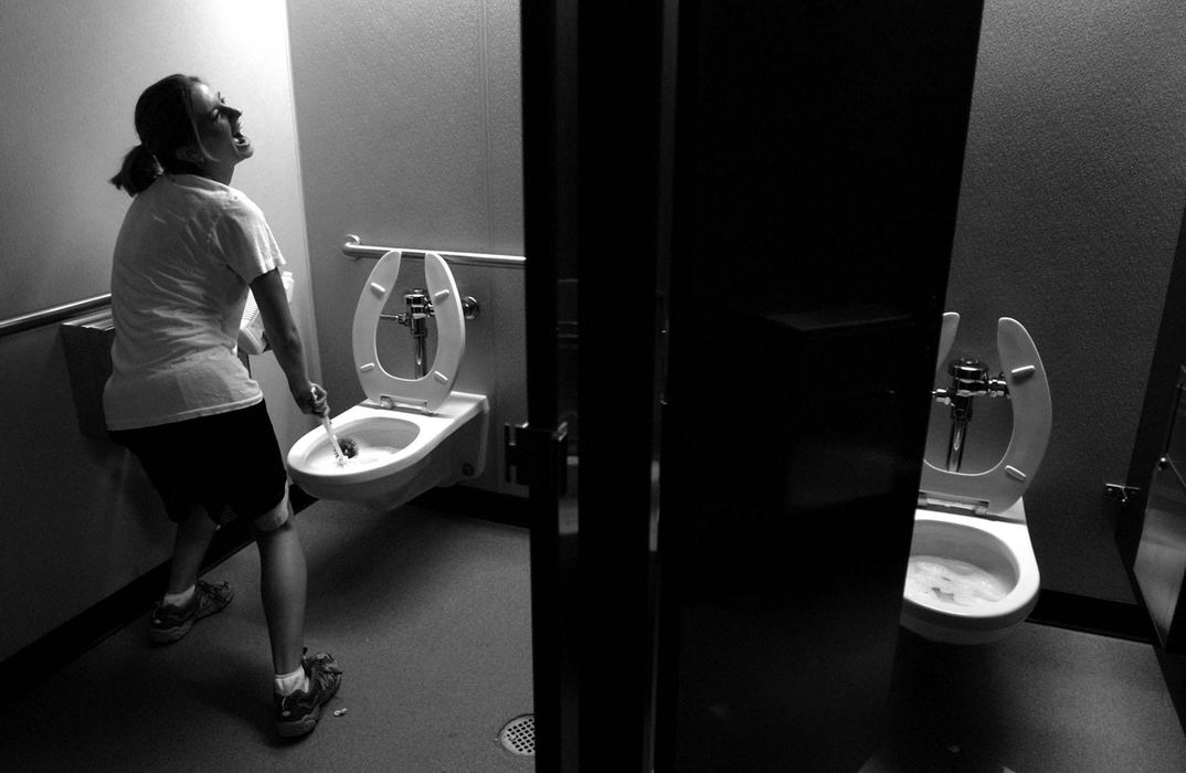 Award of Excellence, Photographer of the Year - Michael E. Keating / Cincinnati EnquirerSarah Sessions belts out a show tune while cleaning the toilets of a local theater company.  Performers work in all aspects of the theater  including food prep, waiting tables, performing and even cleaning the toilets.