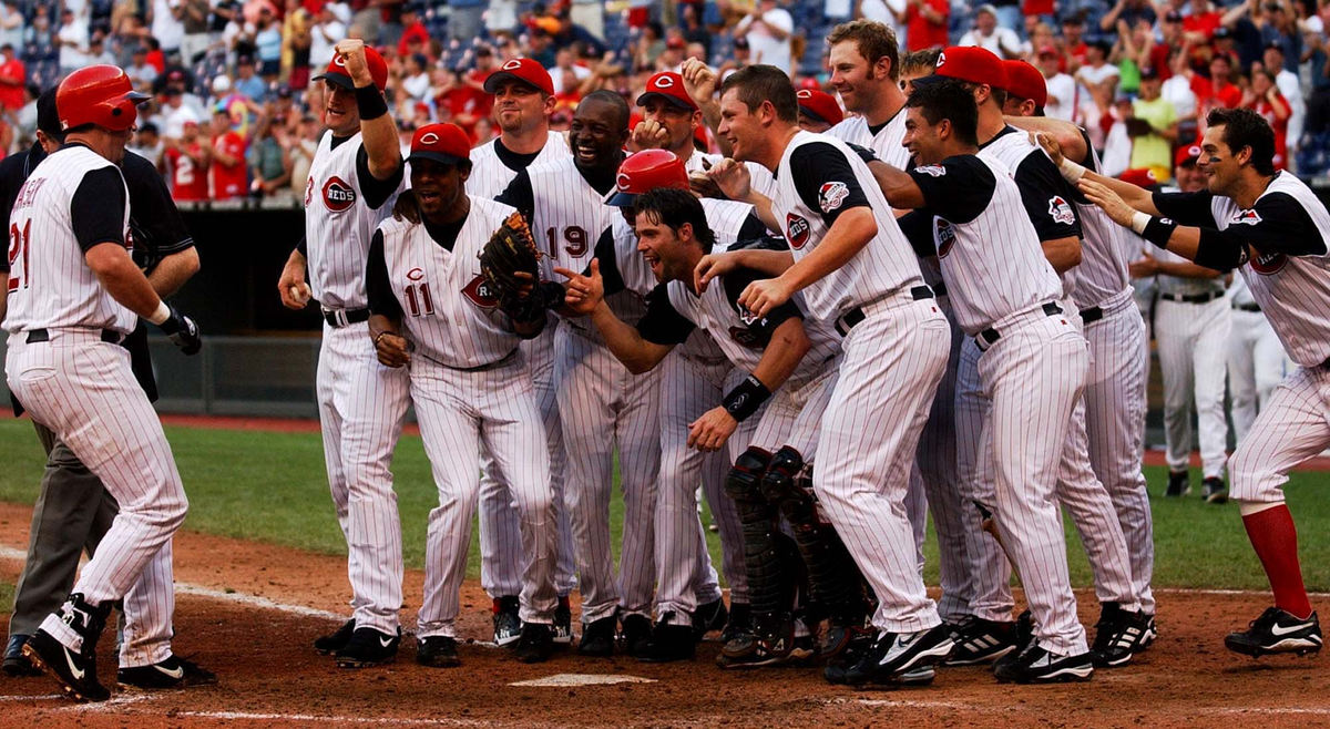 Award of Excellence, Photographer of the Year - Michael E. Keating / Cincinnati EnquirerSean Casey is welcomed at home plate after belting a game winning homer for the Cincinnati Reds.