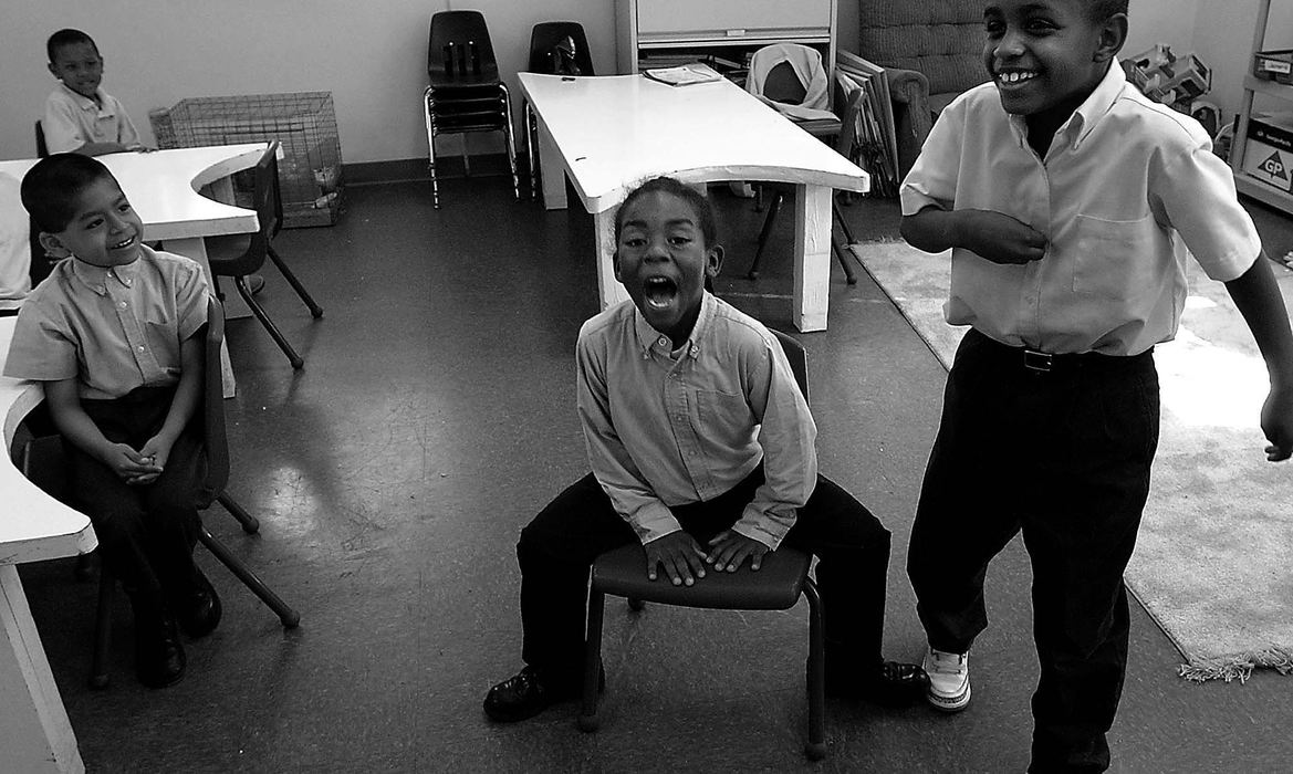 Award of Excellence, Photographer of the Year - Michael E. Keating / Cincinnati EnquirerFun is encouraged as a teaching tool. These students seldom win at anything in life and even a game of musical chairs can be an uplifting motivator and a reason to celebrate heartily. Zaier Dudley (center) reacts as he wins a game of musical chairs. The last student standing (right) is Montinez Humphrey. Students Camilo Rincon (left front) and Jamario McKenzie (left rear) had already been eliminated and watched quietly. 