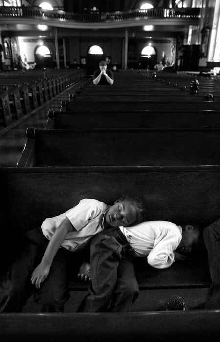 Award of Excellence, Photographer of the Year - Michael E. Keating / Cincinnati EnquirerPeter Claver Latin School students Zaier Dudley (left) and Julian Myers  fell asleep while attending mass at Old St. Mary's Church next to the school. Teacher Nancy Bitter said, "We work them pretty hard, they eat lunch and then go to Mass. They're quiet for a little while and then they sometimes drift off to sleep." 