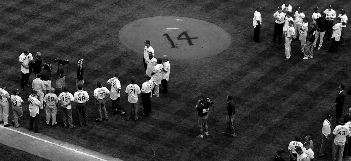 Award of Excellence, Photographer of the Year - Michael E. Keating / Cincinnati EnquirerNumber 14, painted on the dirt of the pitcher's mound, signified the absence of Pete Rose, banned from baseball, during the final game of the Cincinnati Reds regular season. Rose would have his own special night 24 hours later, before a sellout celebrity softball game in the old Riverfront Stadium. Members of the Reds teams from the past gathered on the field...Number 14 is remembered in spray paint in the dirt of the pitcher's mound.