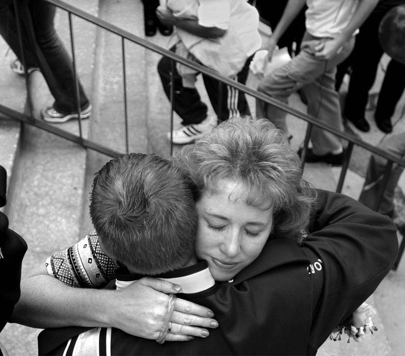 First Place, Photographer of the Year - Ed Suba, Jr. / Akron Beacon JournalSharon Jackson (facing camera) comforts a member of the Northwestern H.S. band outside McGaw Chapel at the College of Wooster after a memorial service for her 14-year-old daughter, Kristen. Kristen, who was a member of the band,  disappeared from the Wayne County Fair and was found murdered four days later. 