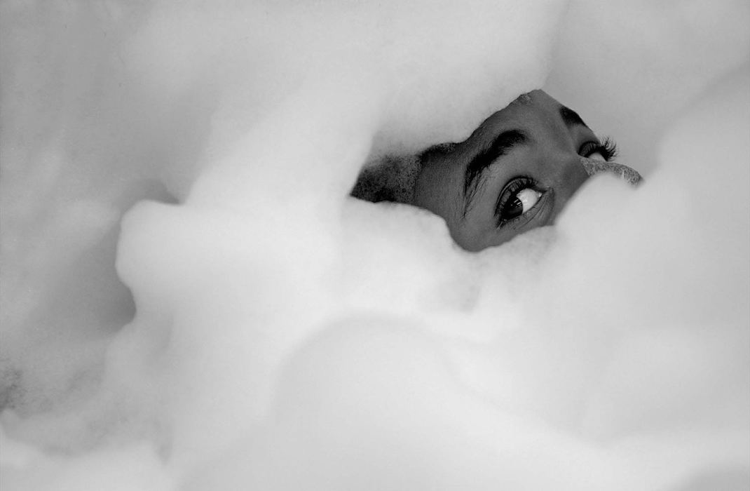 First Place, Photographer of the Year - Ed Suba, Jr. / Akron Beacon JournalLeroy Sutton peeks out from under a cloud of bubbles while taking a bath in the tub room in the burn unit at Akron Children's Hospital. Daily baths were needed to help skin grafts on his stumps to heal and soften scar tissue. Maybe more importantly, he enjoyed taking the bubble baths. The 11-year-old  Akron boy lost both his legs on the morning of December 7, 2001 after being pulled beneath a train while walking to school with his brother, Tony.  