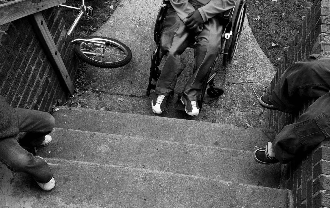 First Place, Photographer of the Year - Ed Suba, Jr. / Akron Beacon JournalWearing both his artificial legs and just wanting to fit in, Leroy Sutton (center) hangs out in front of his Akron home with some of his neighborhood friends after school. 11-year-old Akron boy lost both his legs on the morning of December 7, 2001 after being pulled beneath a train while walking to school with his brother, Tony.  