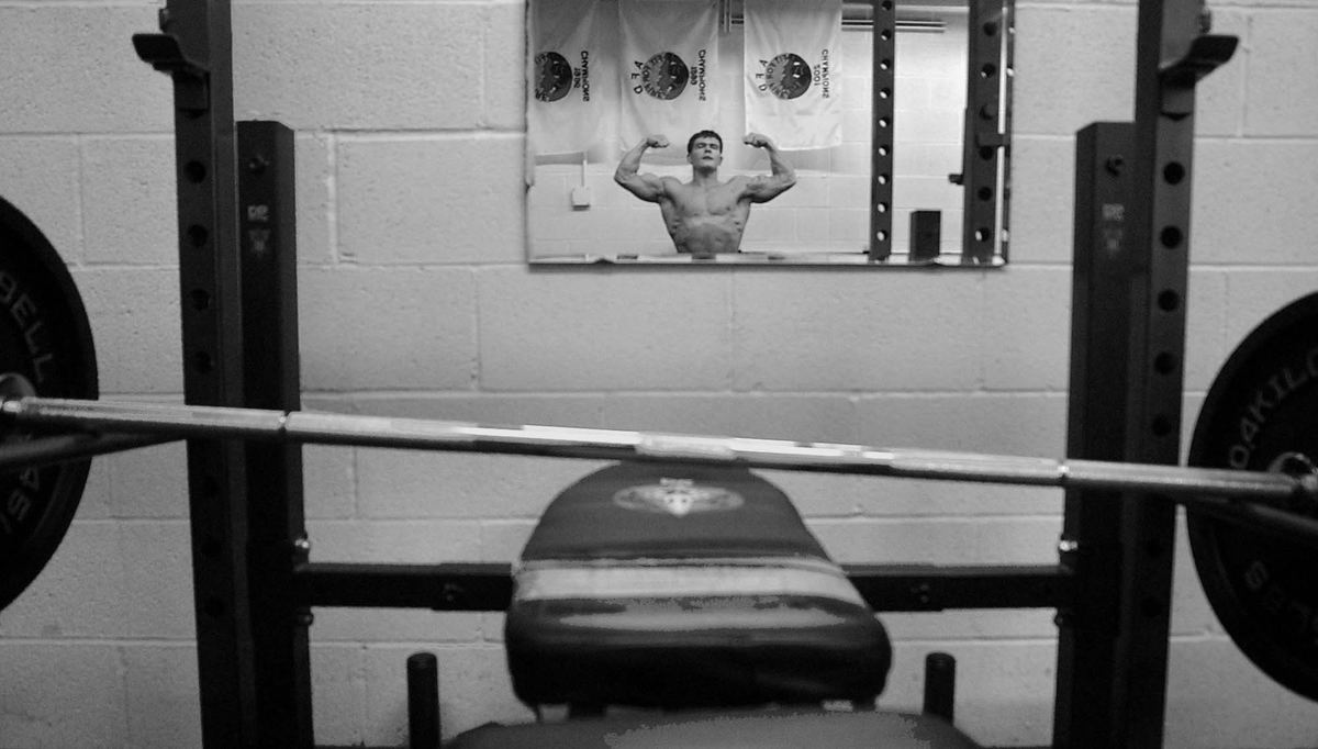 First Place, Photographer of the Year - Ed Suba, Jr. / Akron Beacon JournalAkron firefighter Doug Price goes over his posing routine in the mirror one more time after finishing his workout. The two-minute routine will be the last opportunity for Price to present his physique to the judges. Price is a bodybuilder who has been training for the last year preparing for the 2002 Canton Bodybuilding competition. It will be Price's first contest and he will be competing against bodybuilders from all over the state of Ohio.