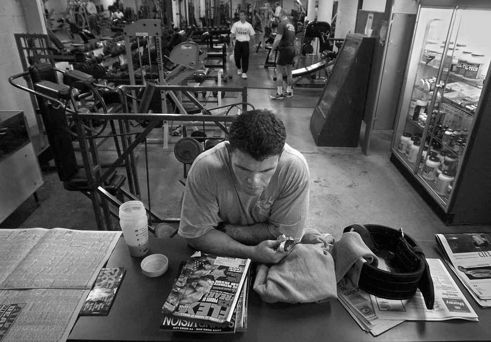 First Place, Photographer of the Year - Ed Suba, Jr. / Akron Beacon JournalAkron firefighter Doug Price has an after-workout "meal" of a powerbar and protein shake. He eats every two hours to keep his metabolism up and running during training but will cut back to only 500 calories a day during the final two weeks of his training. Price is a bodybuilder who has been training for the last year preparing for the 2002 Canton Bodybuilding competition. It will be Price's first contest and he will be competing against bodybuilders from all over the state of Ohio.