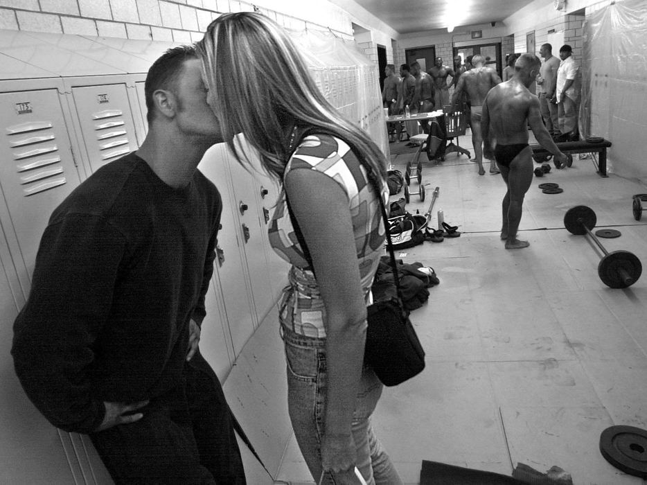 First Place, Photographer of the Year - Ed Suba, Jr. / Akron Beacon JournalAkron firefighter Doug Price, warming up backstage with his competitors, gets a good luck kiss from girlfriend Rachel Croyle before competing in light heavyweight division at the 2002 Canton Bodybuilding Championships at Timken H.S. in Canton. It will be his first bodybuilding competition.