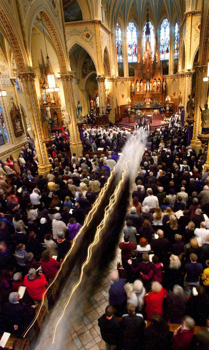 Second Place, Photographer of the Year - John Kuntz / The Plain DealerThe procession leaves the church with the casket of Rev. William Gulas after his funeral service in a time lapse photo December 13, 2002 at St. Stanislaus Church where he was a priest in Cleveland, December 13, 2002.  The church was filled to capacity with several rows of standing patrons in the rear of the church to pay final respects to the father after he was shot to death December 7, 2002.  