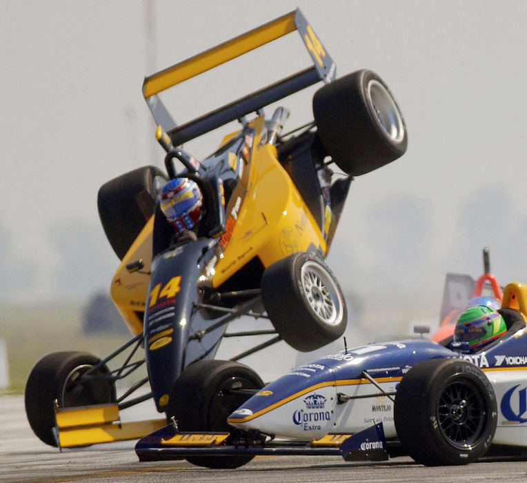 Second Place, Photographer of the Year - John Kuntz / The Plain DealerAlex Figge Toyota Atlantic car flips in the air on turn 1 as he was caught in heavy traffic negotiating the tight turn on lap 3 of the Cart Toyota Atlantic Championship race July 14, 2002 at Burke Lakefront Airport.  Figge and racer Sepp Koster left the race with car damage after the collision.   