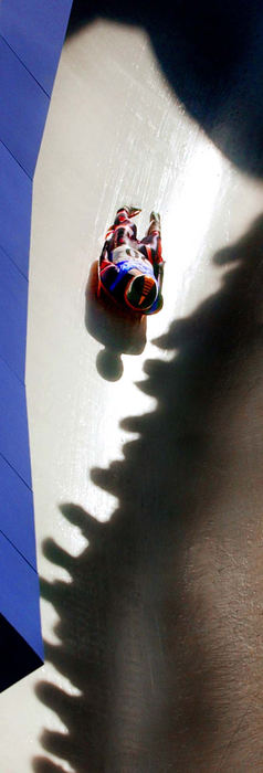 Second Place, Photographer of the Year - John Kuntz / The Plain DealerCanadian luge slider Chris Moffat shoots through turn 15 in a crack of sunlight with the shadows of spectators watching the action February 11, 2002 during the 2002 Winter Olympic Games at the Utah Olympic Park site.  