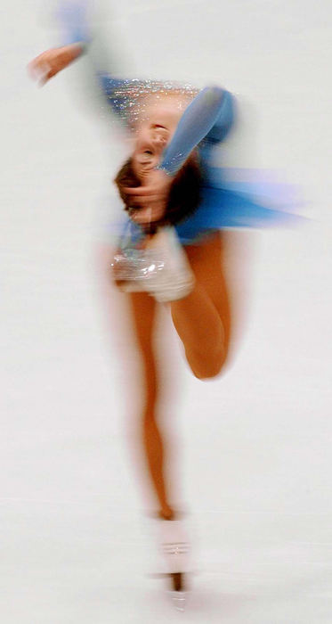 Second Place, Photographer of the Year - John Kuntz / The Plain DealerRussia's Irina Slutskaya spins with her skate up to her head in a time exposure photo during her short program February 19, 2002 at the Salt Lake Ice Center venue during the 2002 Winter Olympic Games.    