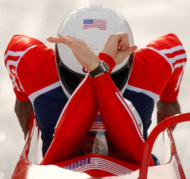 Second Place, Photographer of the Year - John Kuntz / The Plain DealerUnited States' Todd Hays driver of the two-man bobsleigh team crosses his hands to get to the controls as teammate Garrett Hines gets seated behind him after their push off in heat 3 February 17, 2002 at the Utah Olympic Park venue site during the 2002 Winter Olympic Games.  The US team took fourth place in overall time standings.   