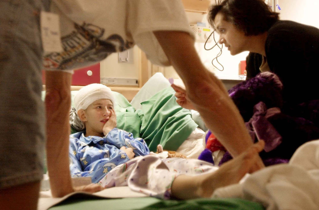 Second Place, Photographer of the Year - John Kuntz / The Plain DealerJohn Vinkler, Jennifer's father, and Dr. Monisha Goyal offer encouragement as Jennifer struggles to remember the color of the felt heart her doctor is holding. Her mother, Patty Vinkler, knew she would only cry during the procedure and stayed away from the hospital that day.    