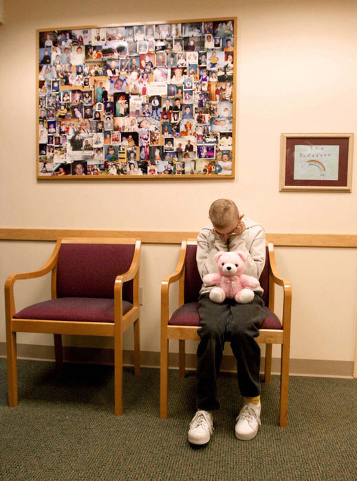 Second Place, Photographer of the Year - John Kuntz / The Plain DealerJennifer Vinkler, 13, of Mentor-on-the-Lake sits by herself in a waiting room chair at Dr. Dody Robinson's office October 10, 2002 at Rainbows Babies and Childrens Hospital while she waits for her father John to finish paperwork and schedule another appointment for Jennifer after getting her stitches removed. Jennifer's seizure epicenters were buried in her memory and linguistic portion of her brain and the brain removal surgery was too risky for Dr.  Robinson to perform. 