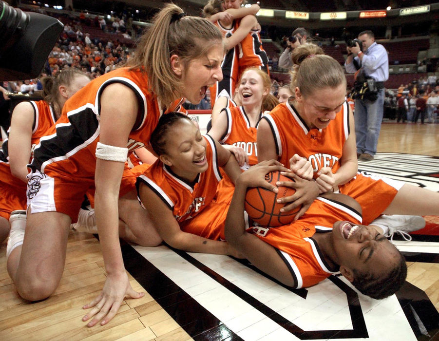 Third Place, Sports Feature - Bob Rossiter / The RepositoryThe North Canton Hoover Vikings #32 Amber Robinson clinging onto game ball is swarmed by teamates following their Girls Div I State Championship trophy following their 58-40 victory over Cincinnati St. Ursula Academy at Value City Arena, Columbus Ohio 