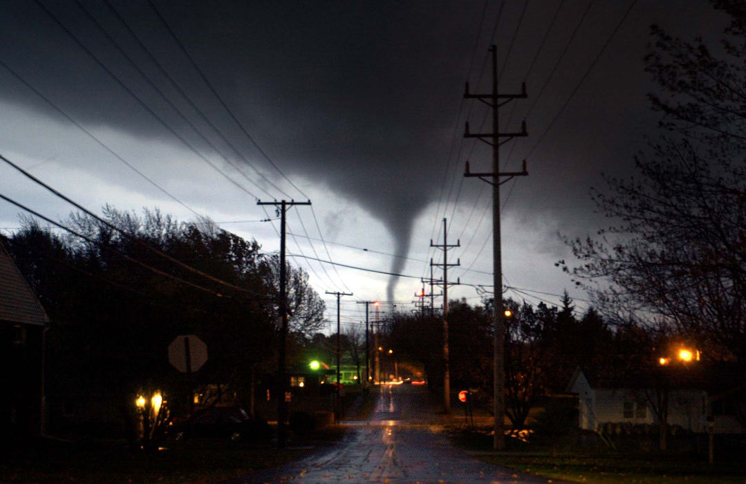 Award of Excellence, Spot News over 100,000 - Allan Detrich / The BladeThis f3 tornado rips through the south part of Tiffin, Ohio.  Several other funnel clouds accompanied this tornado, which destroyed at least 30 homes and businesses in Tiffin. This same tornado also killed one man in nearby Republic, Ohio, injuring dozens. This photo was taken looking south down Nelson St. towards Washington St.