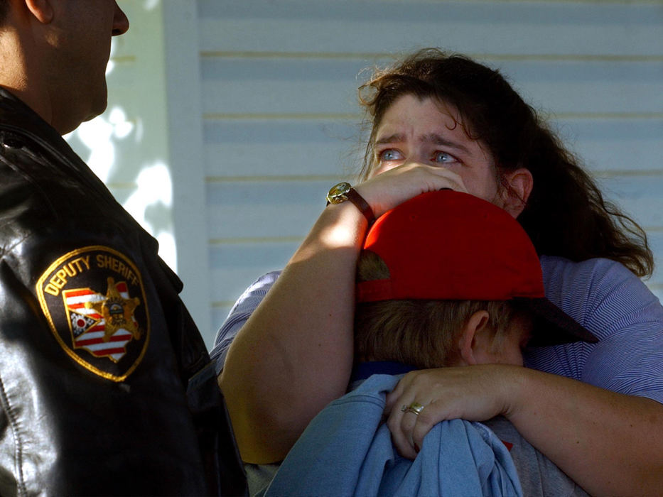 First Place, Spot News under 100,000 - Marshall Gordy / Springfield News-SunStacey Marton, holds her son Xander Lydon, 11, after he was struck while riding his  bicycle to Rockway school by a hit and run driver along New Carlisle Pike.