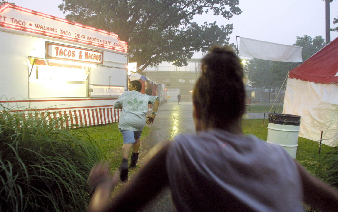 Third Place, Spot News under 100,000 - Shirley Ware / Medina GazetteA storm hit the Medina County Fairgrounds during fair week. As the tornado sirens start to go off, kids start running for cover.