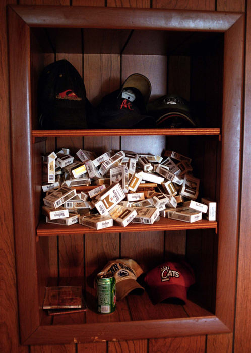 First Place, Student Photographer of the Year - James Patterson / Ohio UniversityEmpty cigarette boxes, a sign of the prevalence of addiction in Adam’s life, pile up on a shelf in his bedroom. 