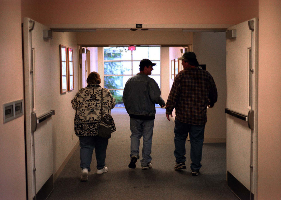 First Place, Student Photographer of the Year - James Patterson / Ohio UniversityAdam's parents, Sharon and Bob Jago walk with him to a meeting with a social worker at the end of a two week stay in the Southeast Psychiatric Hospital. His mother brought him to the hospital after a manic episode in which he broke a window in the auto shop, and drove a van through the shop's garage door. Adam is currently taking the mood stabilizer Zoloft to control his depression.