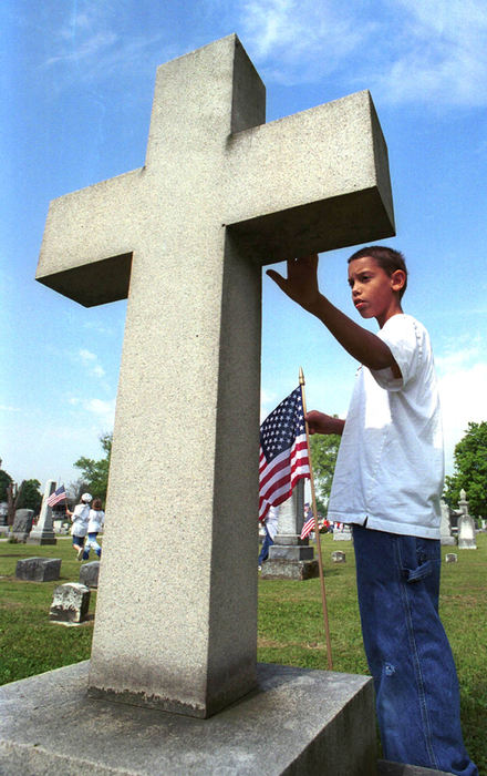 Second Place, Student Photographer of the Year - David Distelhorst / Ohio UniversityAndrew Anderson, 11, pauses by the gravestone of Willoughby Dayton Miller  while placing American Flags in the Maple Grove Cemetery, May 24, 2002. Children from Alexandria Elementary participated in the Memorial Day celebration by placing flags on graves.