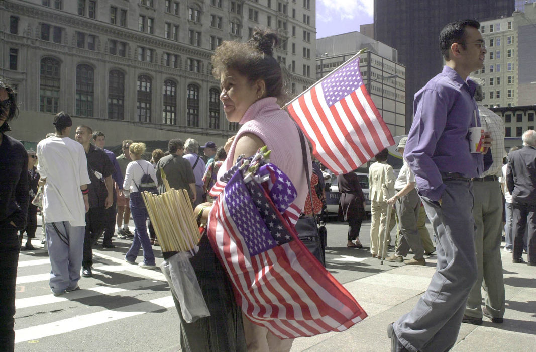 Second Place, Student Photographer of the Year - David Distelhorst / Ohio UniversityVeronica Jara walks down West Broadway in Lower Manhattan selling American flags for two dollars each on the one year anniversary of the terrorist attacks, September 11, 2002.