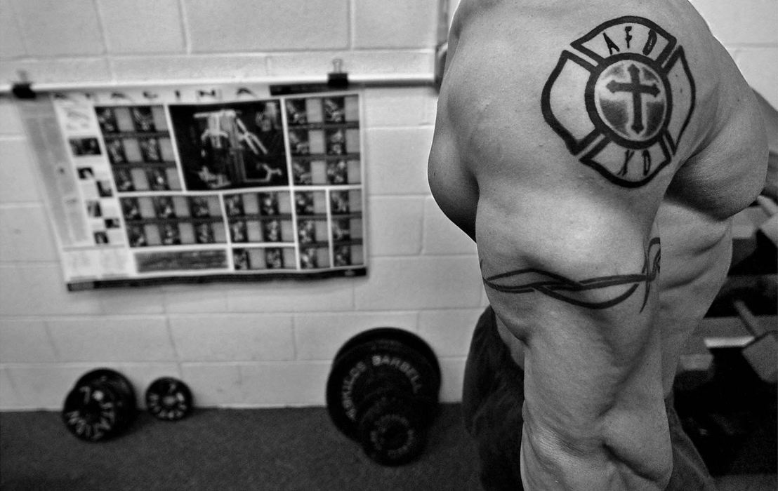 First Place, Sports Picture Story - Ed Suba, Jr. / Akron Beacon JournalAkron firefighter Doug Price flexes his right tricep muscle to check on symmetry and muscle size between excercises. Price is a bodybuilder who has been training for the last year preparing for the 2002 Canton Bodybuilding Championship. It will be Price's first contest and his training will affect all aspects of his life such as work, eating, sleeping and his love life. He will also be competing against bodybuilders from all over the state of Ohio for the title of Mr. Canton.