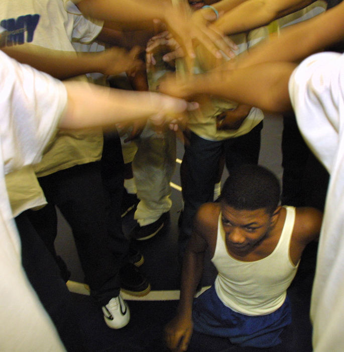 Award of Excellence, Sports Picture Story - Jim Witmer / Dayton Daily NewsRoth Middle School wrestler Bobby Martin is usually in the center of the team spirit cheer at the conclusion of practice.