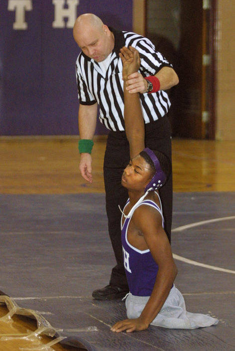 Award of Excellence, Sports Picture Story - Jim Witmer / Dayton Daily NewsBobby Martin's arm is raised by the official after winning his 92 lb. match.