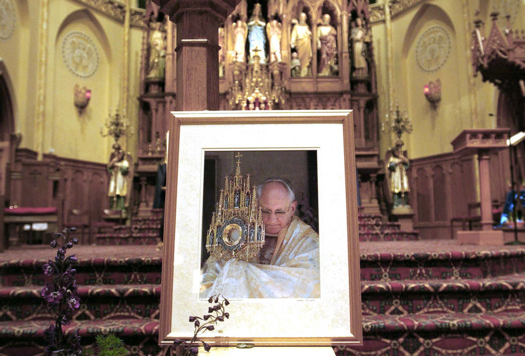 Second Place, Team Picture Story - Dale Omori / The Plain DealerA photograph of the murdered priest was placed at the altar of St. Stanislaus.  Father William Gulas, 69, served as pastor for nine years and was credited with uplifting both the church and the surrounding neighborhood.