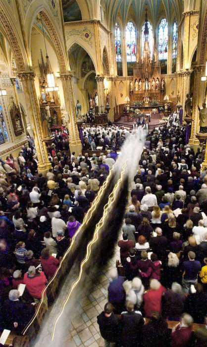 Second Place, Team Picture Story - John Kuntz / The Plain DealerA procession of altar boys carrying candles leads the casket of Father Gulas out of St. Stanislaus.  An overflow crowd paid final respects.