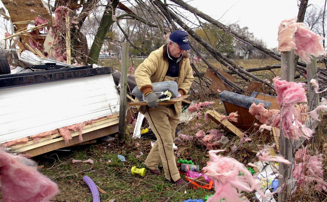 Third Place, Team Picture Story - Lisa Dutton / The BladeJames Schmidt picks through the remains of his home, the day after a tornado struck NW Ohio.