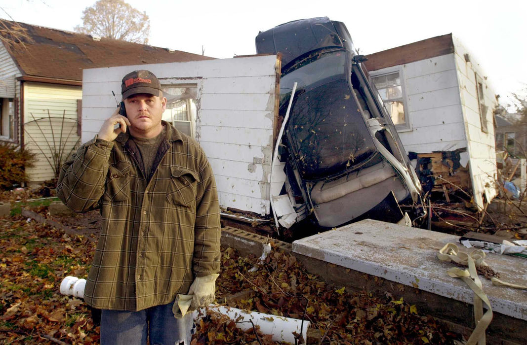 Third Place, Team Picture Story - Allan Detrich / The BladeDave Weenger of the who is stunned at what he found at his grandmother's, Marveleen Weenger's home on Cedar St. as he calls the insurance agent. Marveleen 78, was sitting watching the TV when a car slammed into her home, knocking her to the ground and across the room.