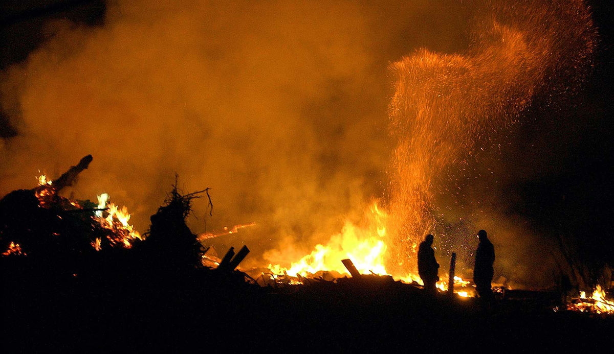 Third Place, Team Picture Story - Andy Morrison / The BladeGreg Gamble, left, and his uncle Dean Mosier watch the remains of Gamble's barn burn as they cleanup his Van Wert property. 