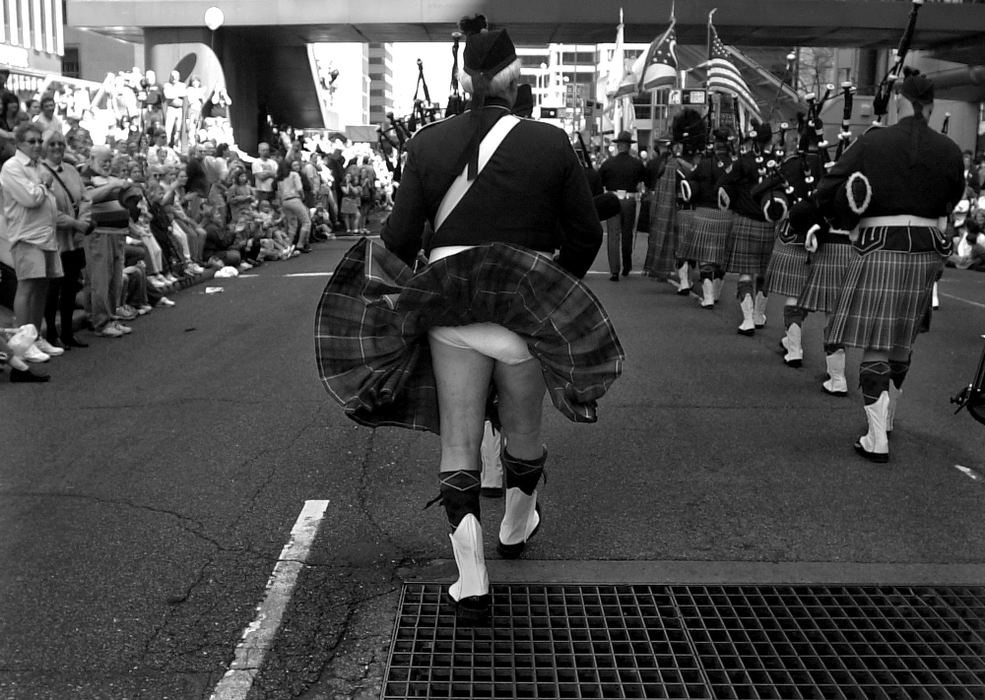 First Place, Enterprise Feature - Michael E. Keating / Cincinnati EnquirerAir from a street grate provides a glimpse under the kilt of a bagpiper marching in the annual St. Patrick's Day parade. It also provides an amended answer to that old question, "What do they wear under there?"