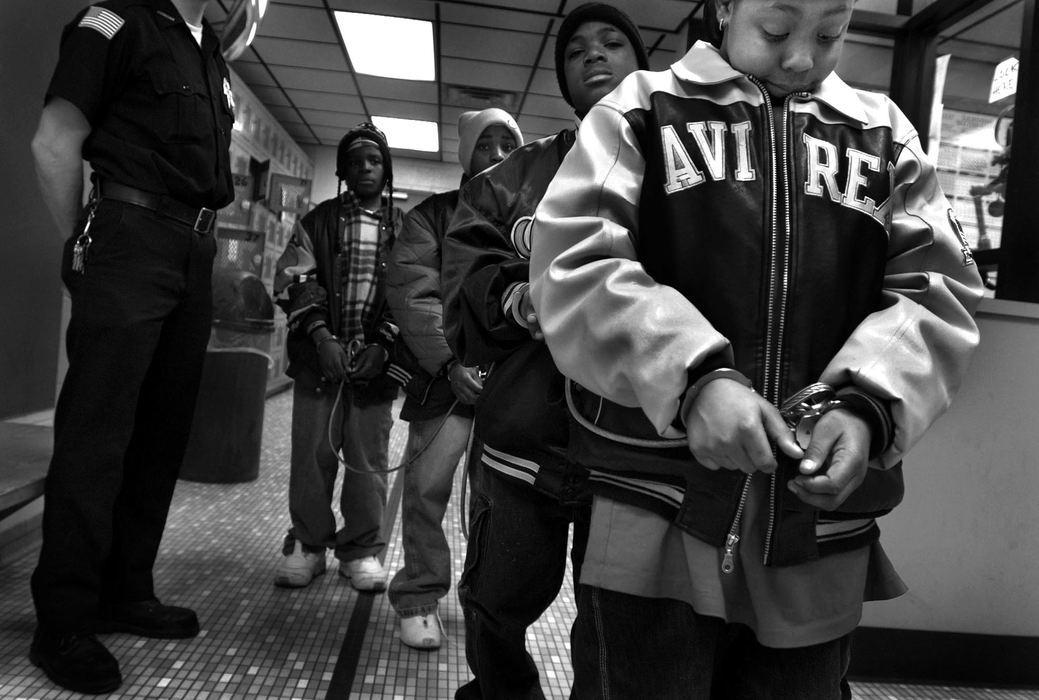 Second Place, Feature Picture Story - Dale Omori / The Plain DealerRobert Beane, age 12, far right, is a child on the edge--on the path to adult prison, but still young enough to change his course. Parents and schools struggle to straighten out kids like Robert.  He was arrested with his friends for disrupting traffic.  Upon checking, police found he had an outstanding warrant for fighting.  He was sent to the Lorain County Juvenile Detention Home.  Juvenile courts, where kids often end up, usually have a range of options: diversion programs, home-monitoring ankle devices, detention cells.  Sometimes, the kids still slip through the cracks.  With a child like Robert, there are no easy answers.