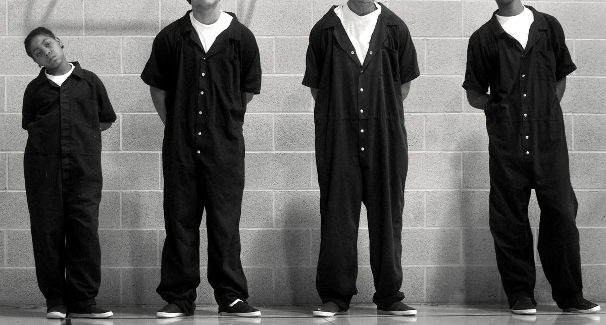 Second Place, Feature Picture Story - Dale Omori / The Plain DealerIn a baggy jumpsuit, Robert Beane lines up against the wall with others at the Lorain County Juvenile Detention Home.  The boys line up in this manner every time they move from one part of the home to another.  Most of the boys in the home are four or five years older than Robert.