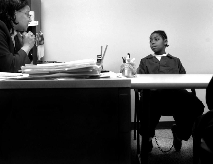 Second Place, Feature Picture Story - Dale Omori / The Plain DealerCharlita Anderson-White, a Lorain County magistrate, talks to Robert after he had been locked up for three weeks.  He wanted to admit his wrongdoings and go home.  White had to explain to Robert his rights to a lawyer and trial.