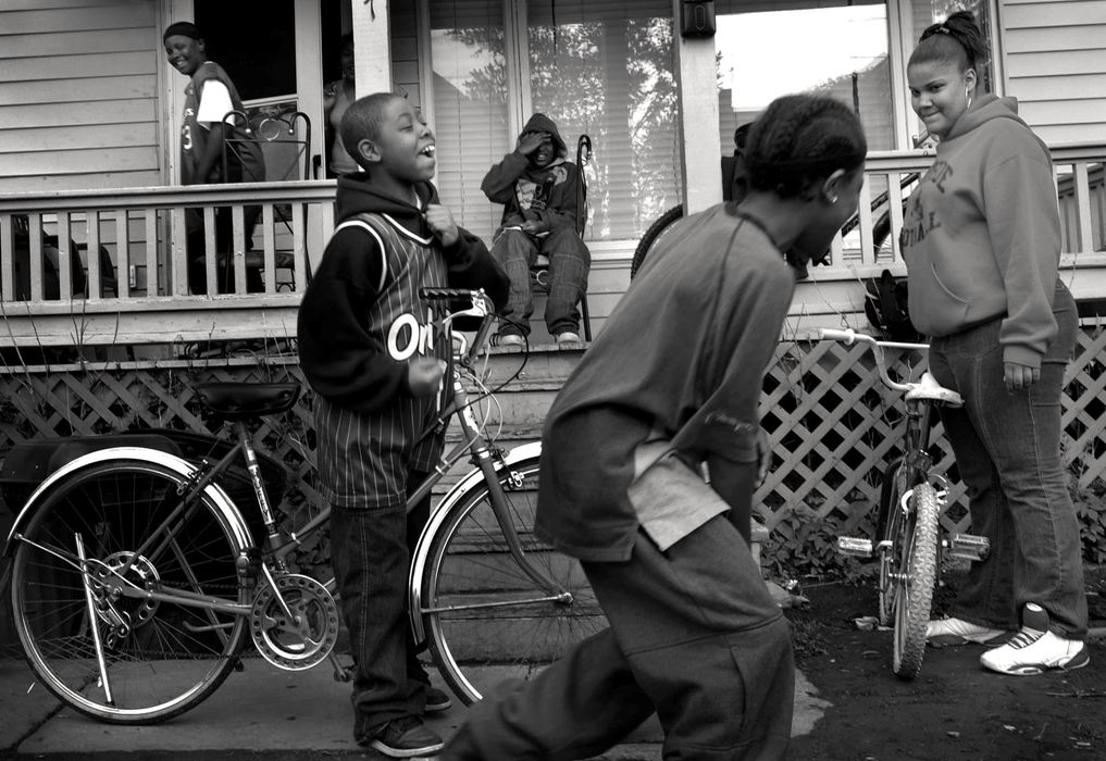 Second Place, Feature Picture Story - Dale Omori / The Plain DealerWhile his mom is at work, Robert Beane, on bike, horses around with friends down the street from his home.  He's not supposed to leave the house while on probation, but he often does.