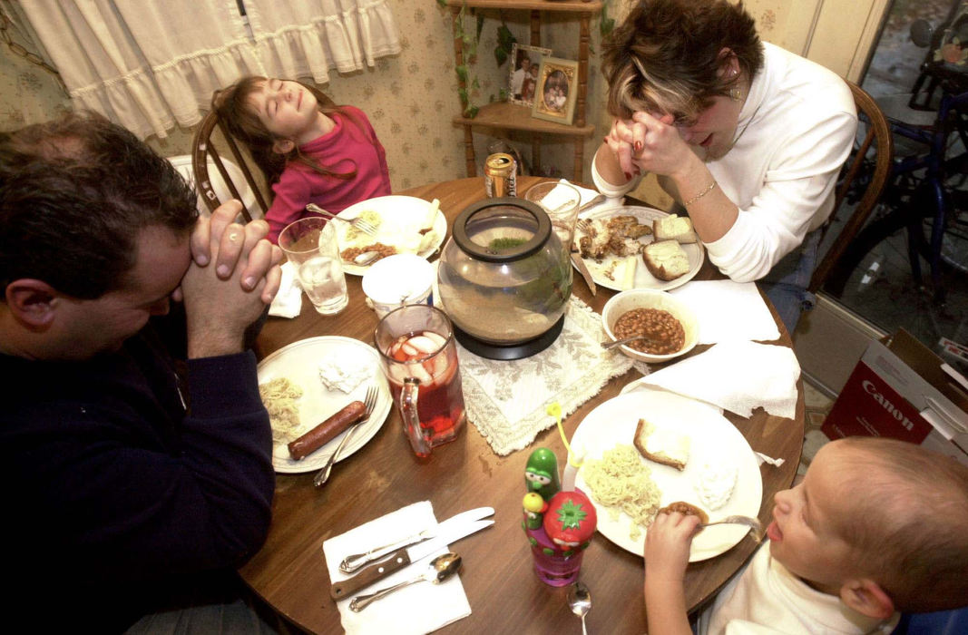 Award of Excellence, Feature Picture Story - Daniel Melograna / The News JournalMonte leads the family in prayer Oct. 25 before dinner.