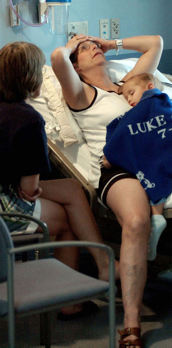 Award of Excellence, Feature Picture Story - Daniel Melograna / The News JournalIvy Ervin leans back as she talks with Peggy Lintern Monday, July 15, 2003 while her son, Luke, sleeps on her chest at Children's Hospital in Columbus.