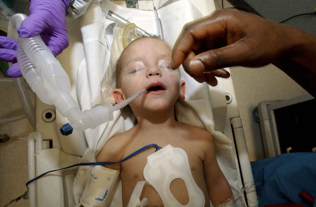 Award of Excellence, Feature Picture Story - Daniel Melograna / The News JournalKari Heinrich holds up oxygen tubes Feb. 7 as Anesthesiologist Lami Dairo makes sure all is well after putting Luke Ervin, 2, under for his MRI at Children's Hospital in Columbus.