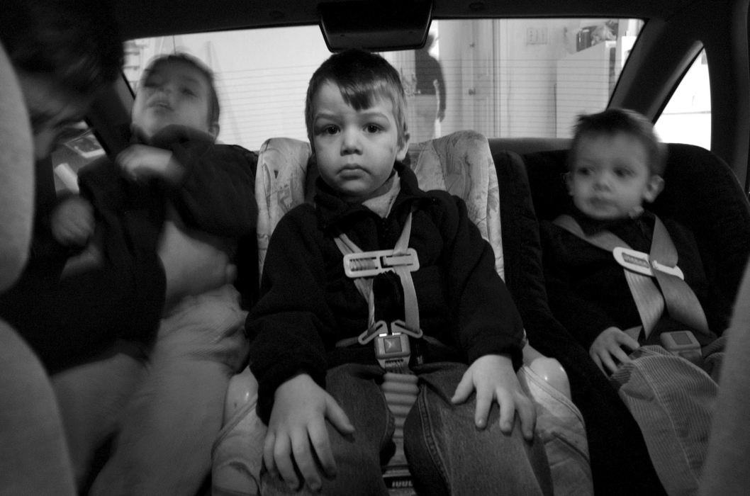 First Place, Feature Picture Story - Dale Omori / The Plain DealerMark Augier seats Henri, left, after Henri ran off instead of climbing into his mother's station wagon with brothers Marcel, middle, and Chritophe. 